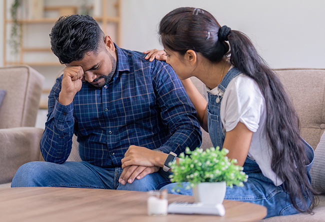 Compassionate wife giving comfort and encouragement to husband in recovery