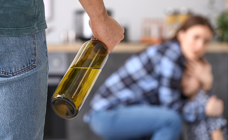 Alcoholic parent acting in an aggressive mood and scaring the family