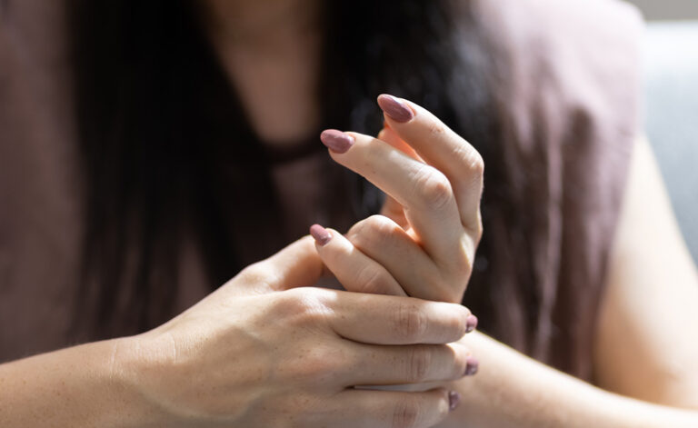 Women suffering from health anxiety fidgeting with her fingers