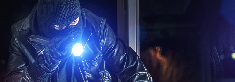 Drug addict breaking into a house at night