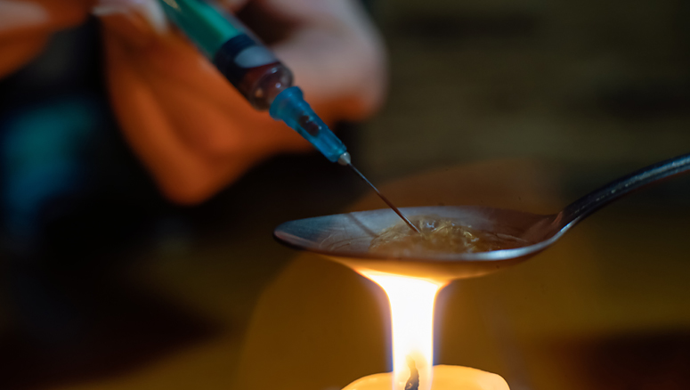 Cooking up heroin ready for taking by addict