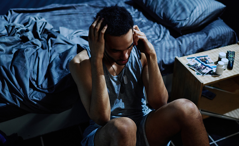 Man suffering from depression due to drug addiction calling a helpline for support