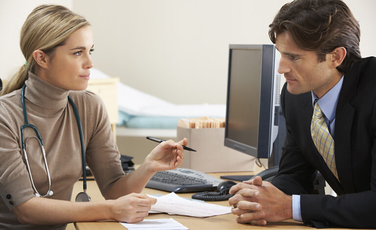 Female doctor discussion medication with businessman suffering with depression