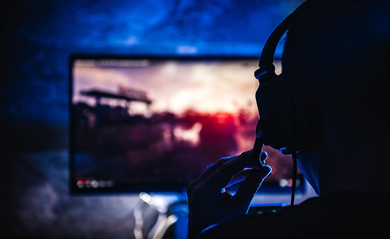 Addicted online gamer playing game late into the night