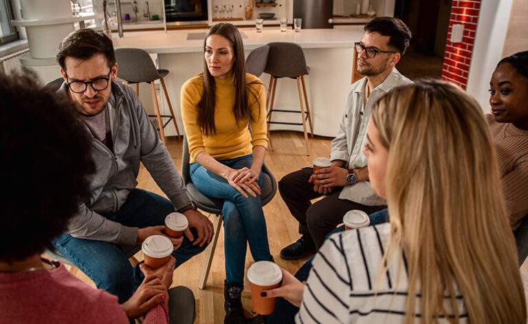 Member of Alcoholics Anonymous meet up for a coffee and to share their experience of alcoholism and recovery