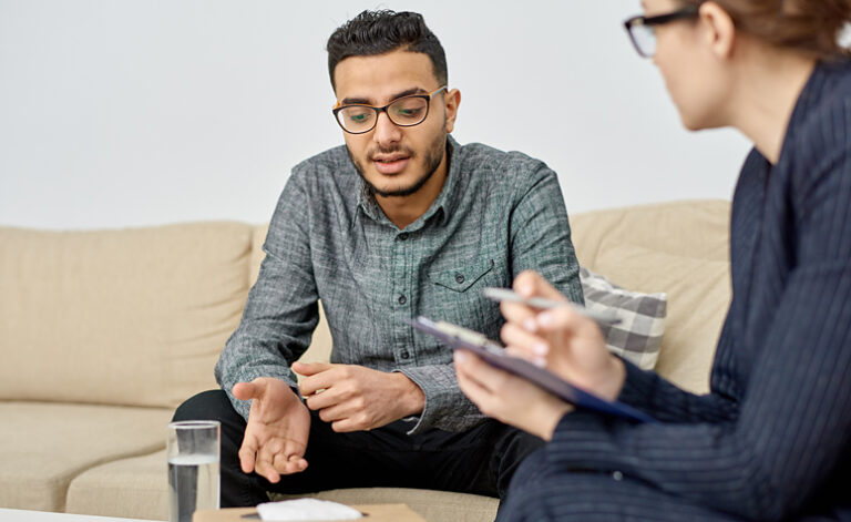 Man in therapy discussing his internet addiction issues