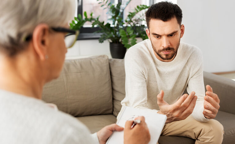 Man in therapy session with mental health counsellor discussing depression and suicidal thoughts