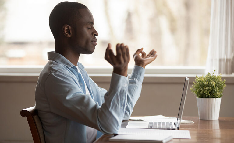 Man performing breathing exercises to calm symptoms of anxiety