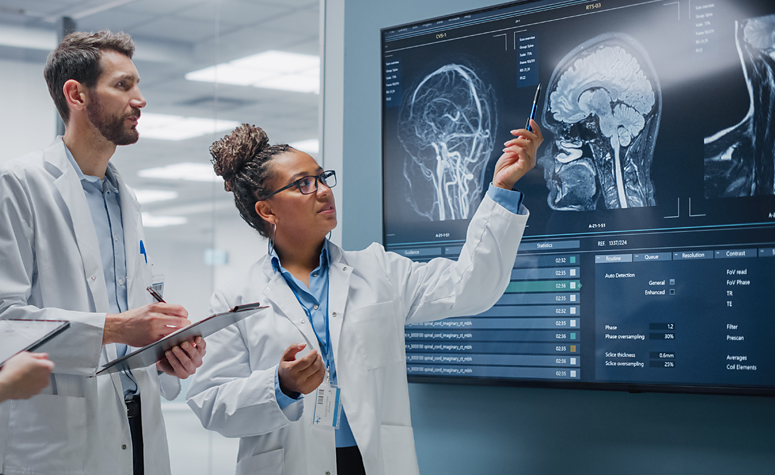 Medical scientists examining brain scans of patient suffering from addiction