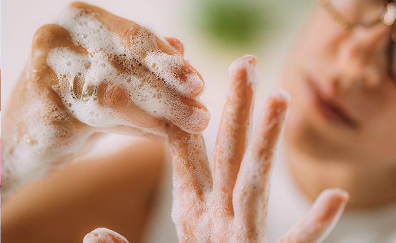 Woman suffering from OCD washing hands repeatedly.