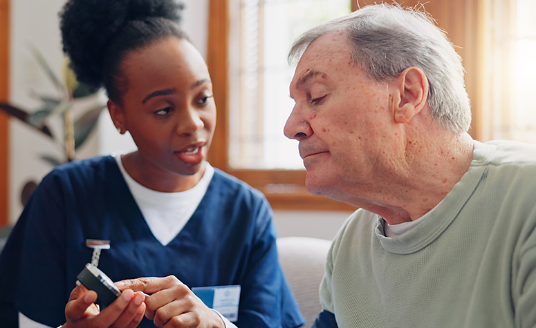 Patient in rehab treatment centre sat with medical nurse professional having examination