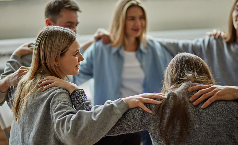Alcoholics Anonymous group comforting relapsed women