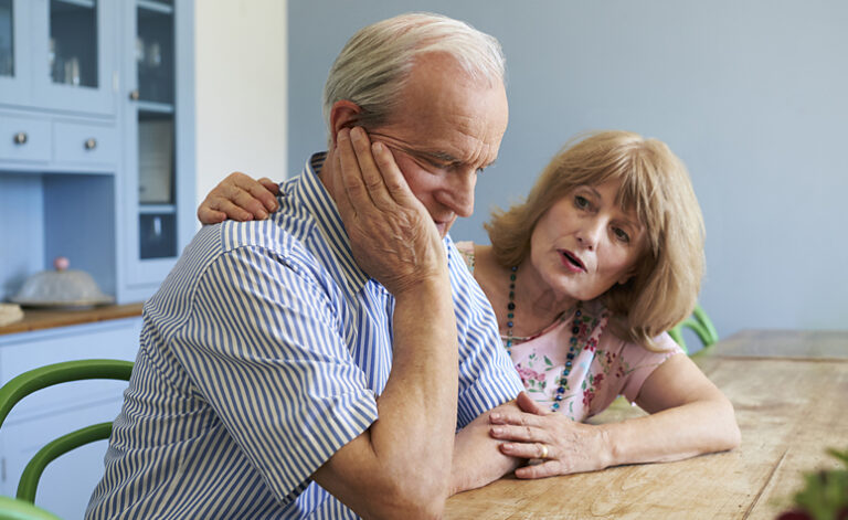 Wife comforting her husband who is suffering from depression