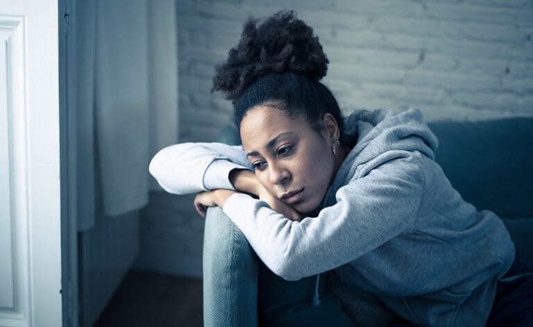 Woman sat at home suffering from depression