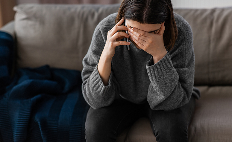 Woman struggling with alcoholism calling a helpline