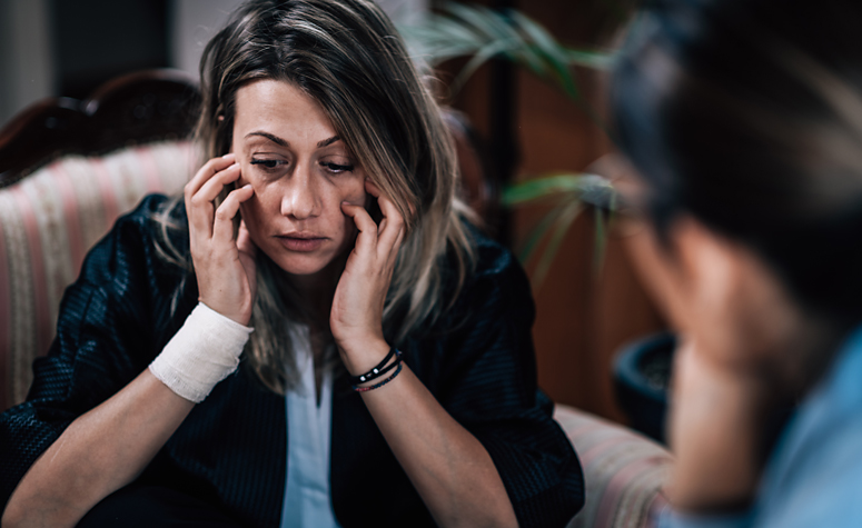 Woman in CBT therapy session discussing her addiction problems
