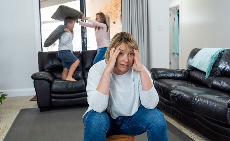 Woman struggling with depression trying to cope with lively children
