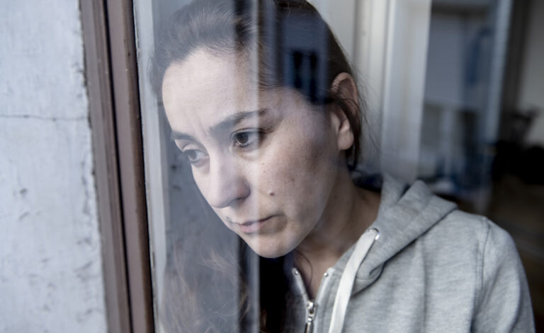 Woman with depression staring out of the window