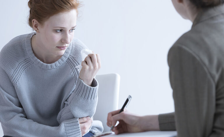 Young lady in bulimia therapy session at AddictionRehab