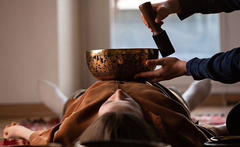 Women relaxing during a gong bath therapy session
