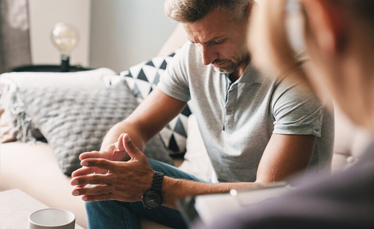Man suffering with adjustment disorder in a CBT therapy session