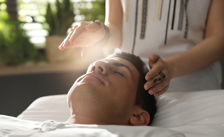 Man receiving Reiki therapy as part of an addiction treatment plan