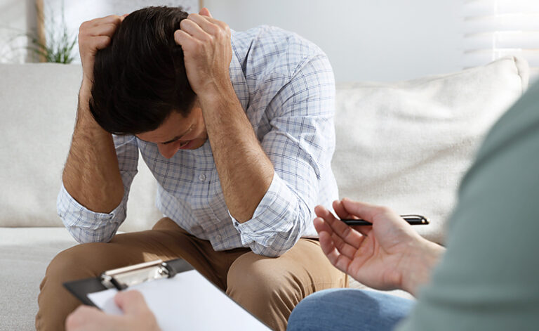 Man in therapy session with specialist CBT panic attack counsellor