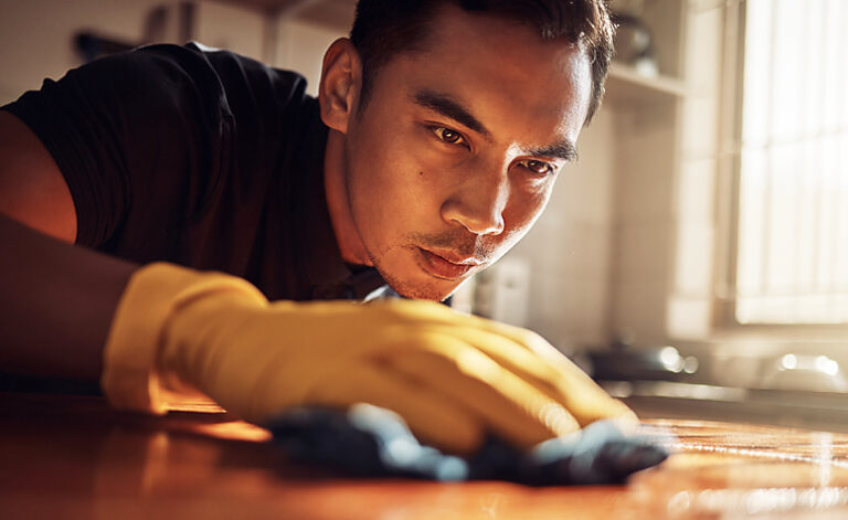 Man with OCD obsessively cleaning his kitchen