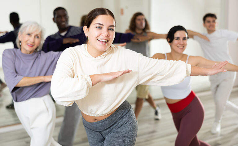 Group in recovery dancing during a music therapy session