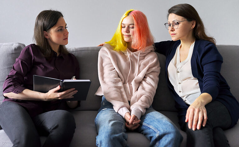 Teenager discussing self-harm with parent and psychologist