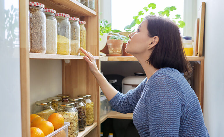 Woman with OCD obsessing over the precise alignment of food jars in her pantry