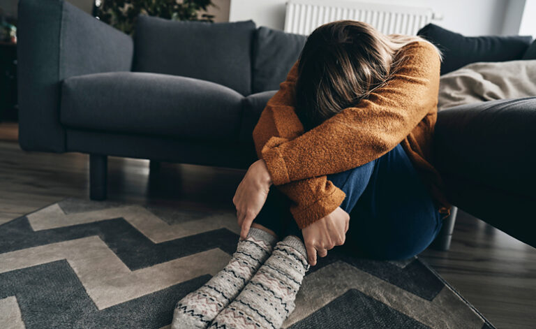 Women suffering from adjustment disorder depression sat on the floor