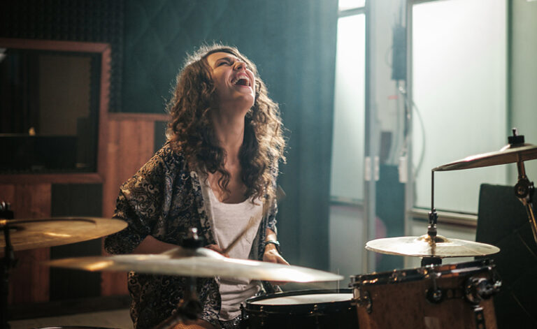 Women letting her emotions free playing drums in music therapy