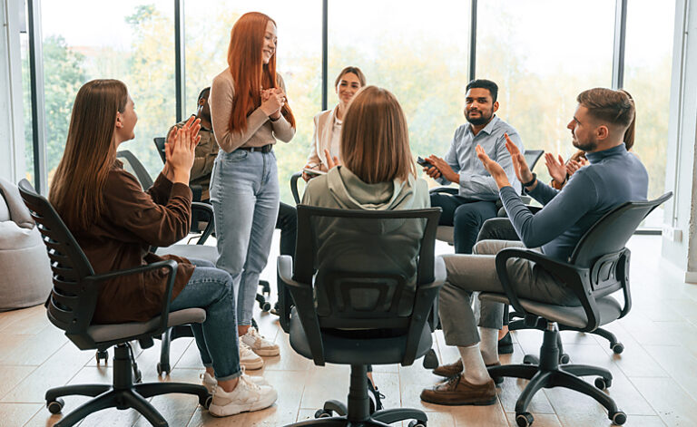 Woman sharing her journey and experience of addiction and recovery in a 12 step program meeting