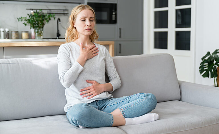 Woman using deep breathing techniques to calm her anxiety