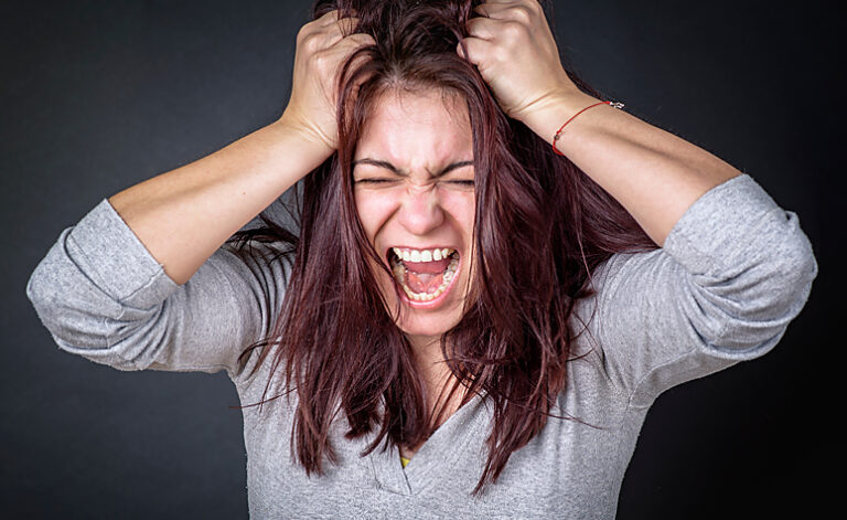 Woman pulling her hair out due to stress and struggling with Trichotillomania