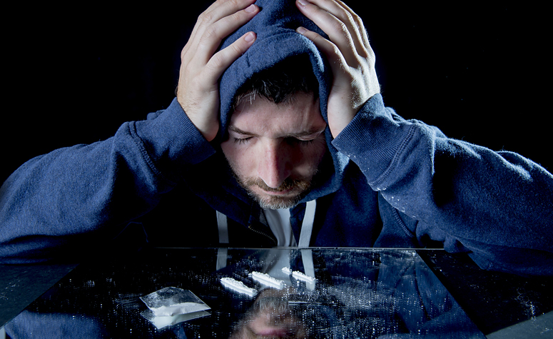 Man struggling with his cocaine addiction, depressed and wishing to stop his addiction