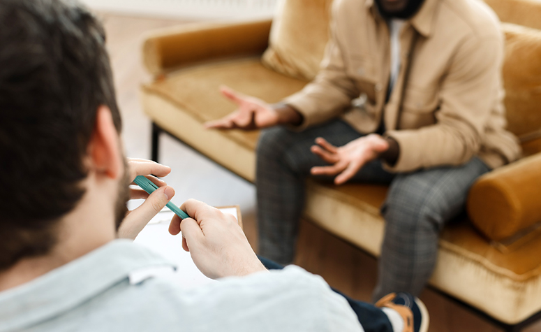 Man working with mental health specialist discussing with problems