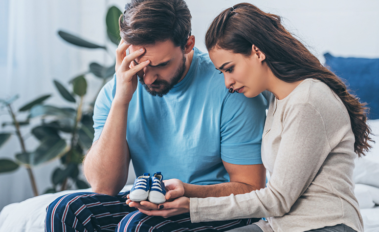 Couple trying to cope with their grief over the loss of their baby