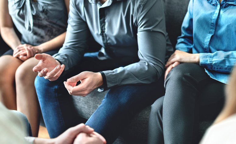 Group of people discussing their alcohol addiction problems in group therapy
