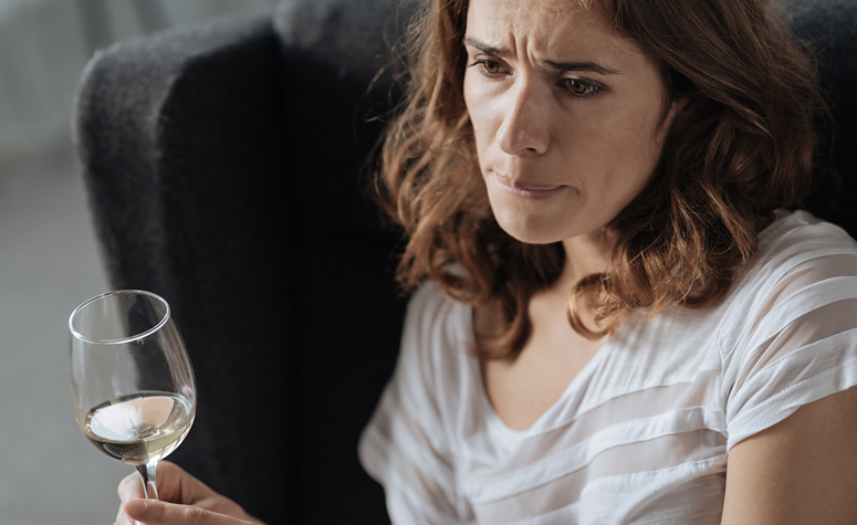 Woman suffering with depression and anxiety due to alcohol dependancy withdrawal symptoms