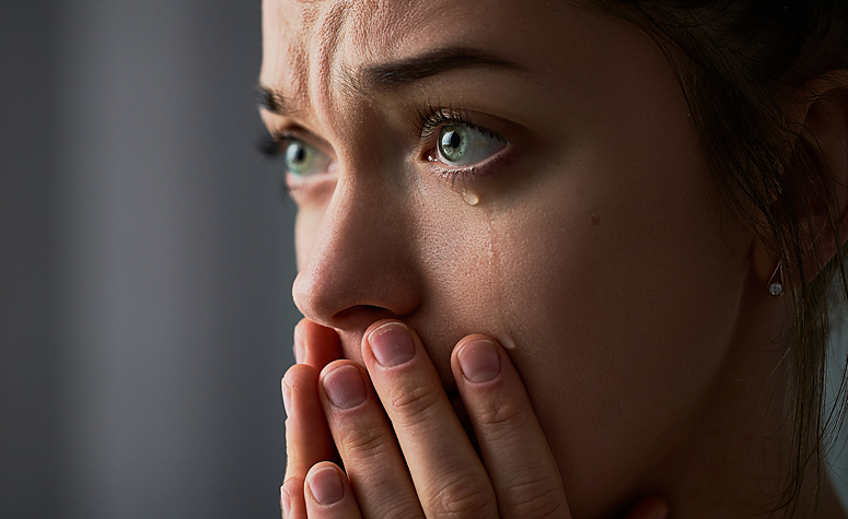 Woman crying and struggling with her bereavement and grief