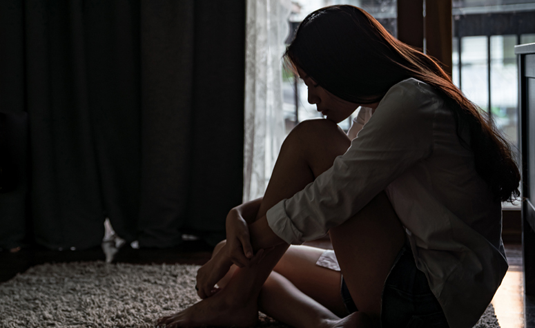 Woman struggling with the symptoms of addiction in need of professional help