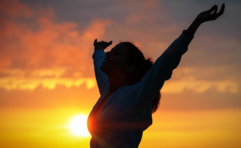 Woman celebrating her new found freedom from addiction following psychodynamic therapy